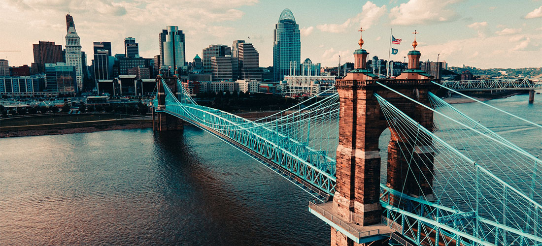 A bridge in Cincinnati with buildings behind it.