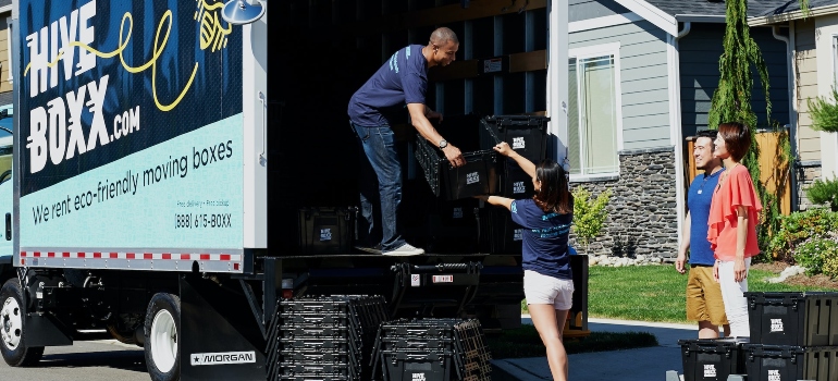 Movers from cross country moving companies Evanston carrying boxes