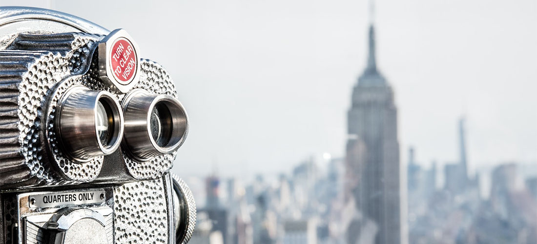 A binoculars with the Empire State Building in the background.