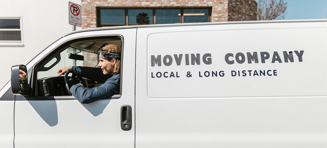 A man working for long distance moving companies Kentucky driving a van.