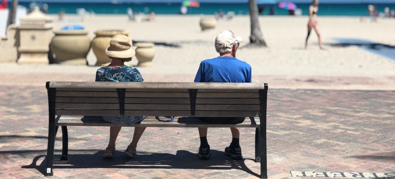 Elderly couple enjoying a beach after moving from Charlotte to Miami