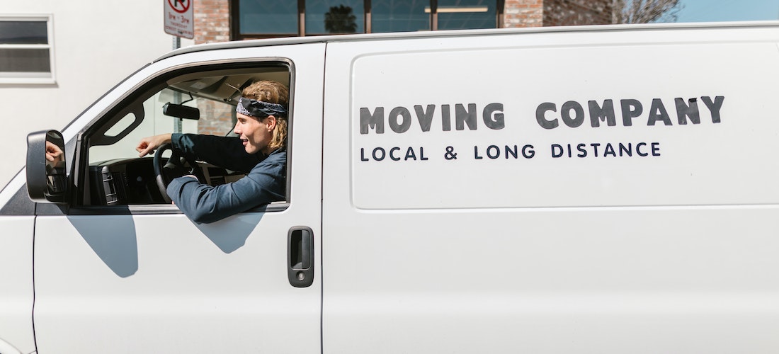 A man working for long distance moving companies Nebraska sitting in the van