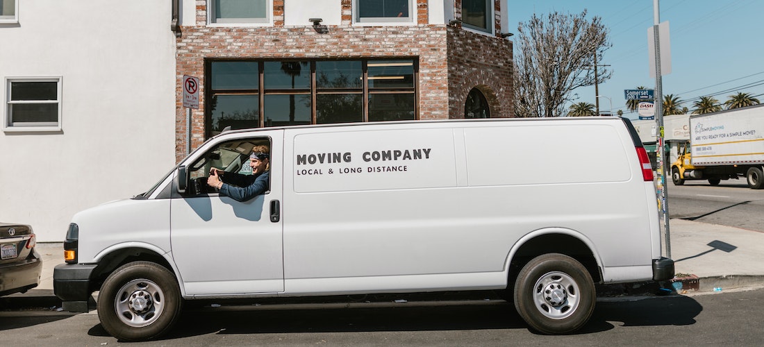 A white van of long distance moving companies Iowa parked in the street.