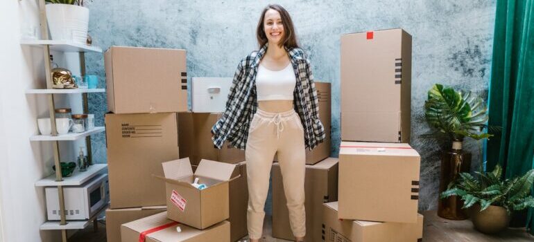 A person standing with packed boxes