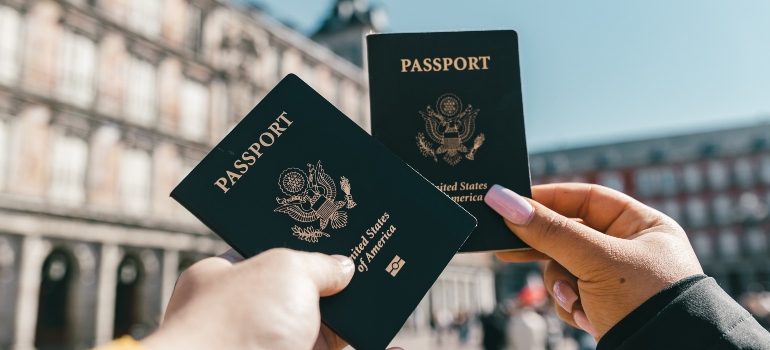 two people holding passports