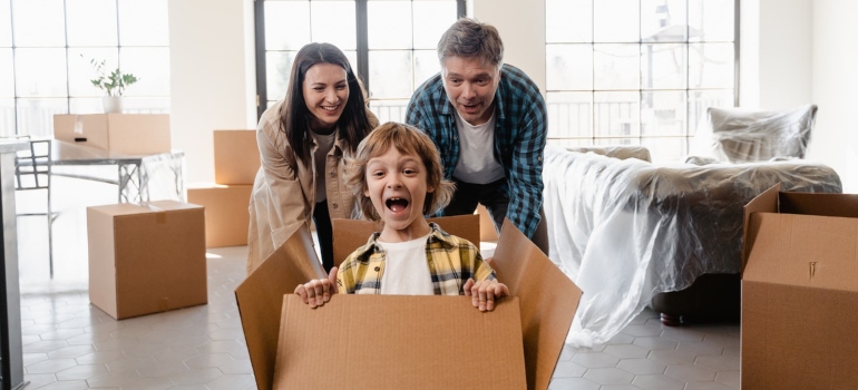 A happy family with a smiling child in a box