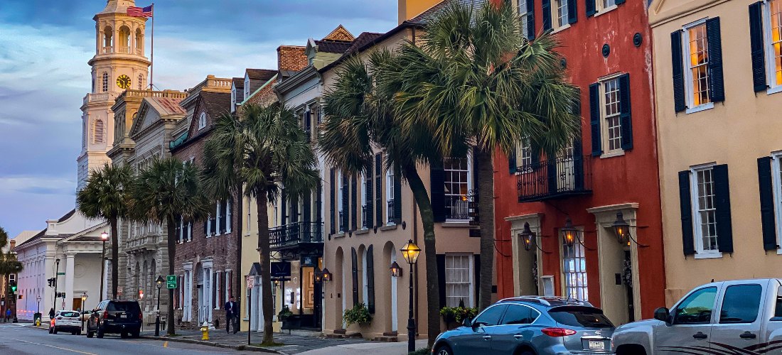 A photo of a street in South Carolina surrounded by palm trees and buildings