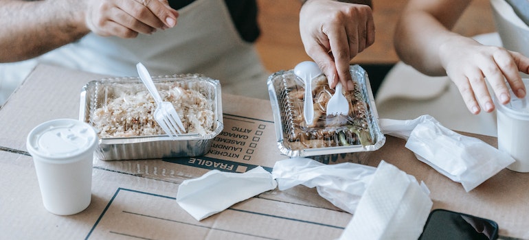 A couple preparing food to pack for their moving day, which is one of the great ways to simplify your move