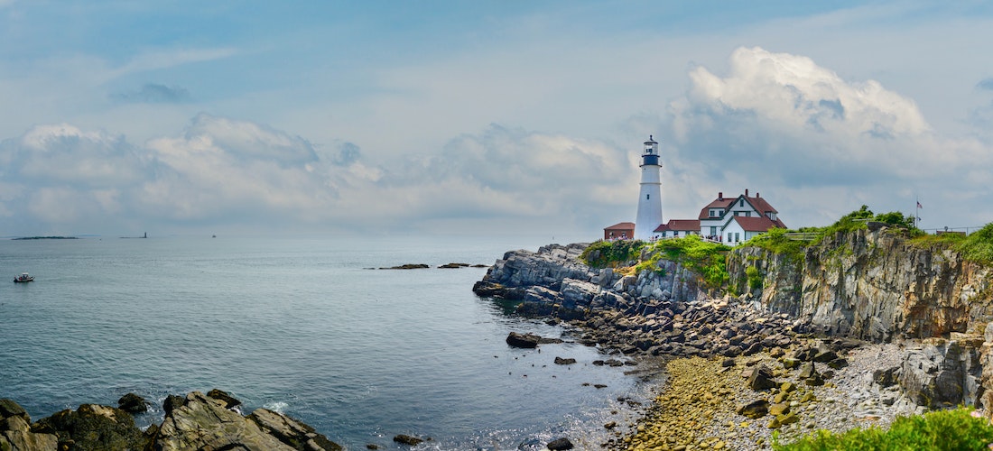 A lighthouse on a cliff in Maine