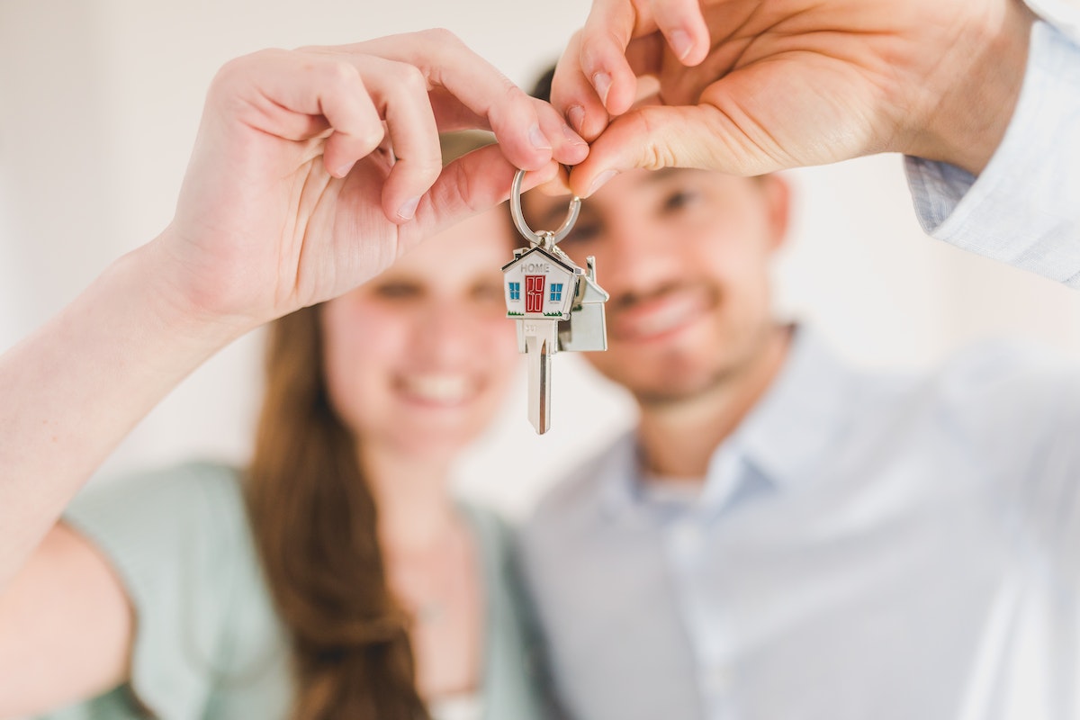A couple holding a key