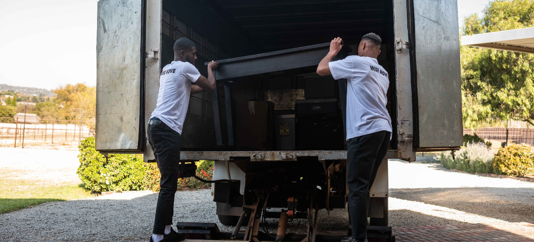 Two movers from long distance moving companies Massachusetts loading things into the truck