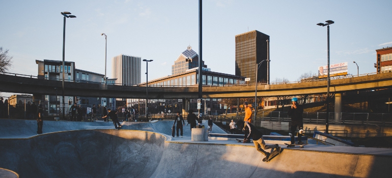 People skating in Rochester, one of the places that pay you to move there