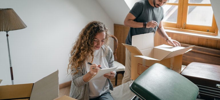 A person looking at a notebook, solving some of the challenges of moving locally