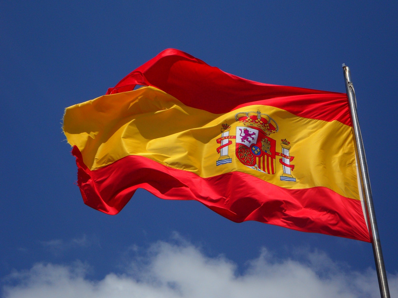A flag of Spain waving through the air