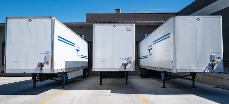 A row of moving vans, which are costly to rent, which tells us about the benefits of renting a portable storage container