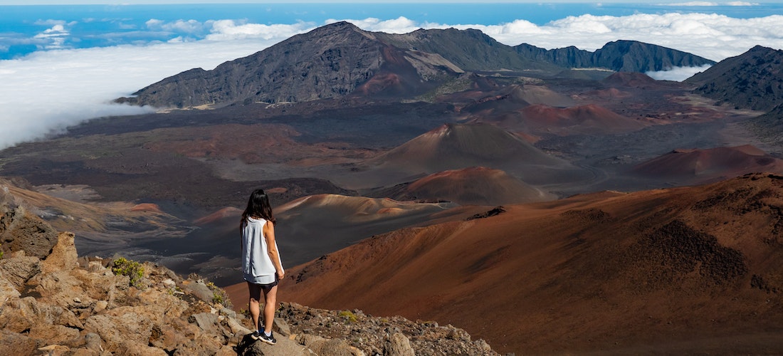 A girl standing on top of the mountain in HI