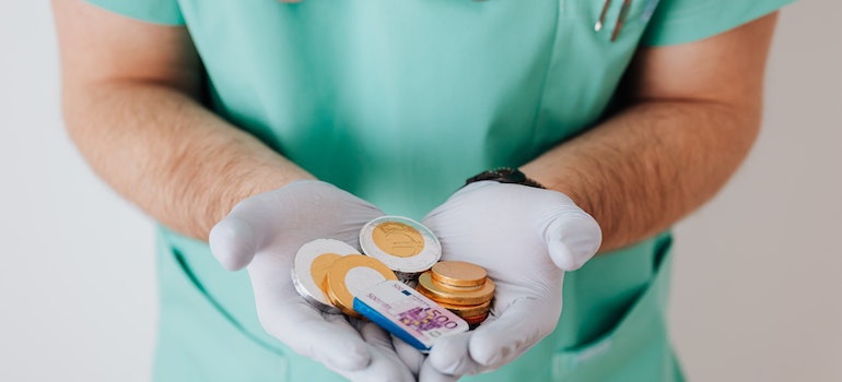 Doctor holding chocolate money for children