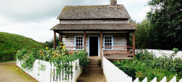 A house with a nice yards surrounded by plants