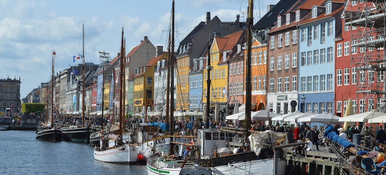 View of colorful buildings and boats you can see after moving to Denmark from US