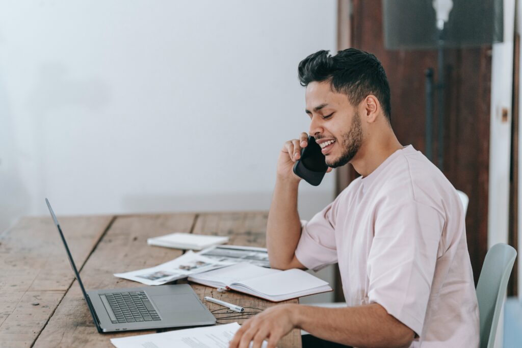 Man talking to a car shipping company on the phone