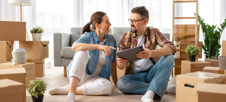 A couple looking for best cross country mvoers Bethlehem on a tablet