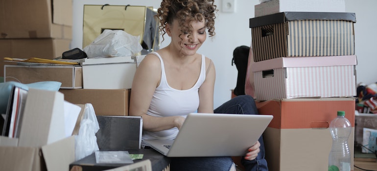 A woman on a laptop, looking for ways to organize your new home after a move