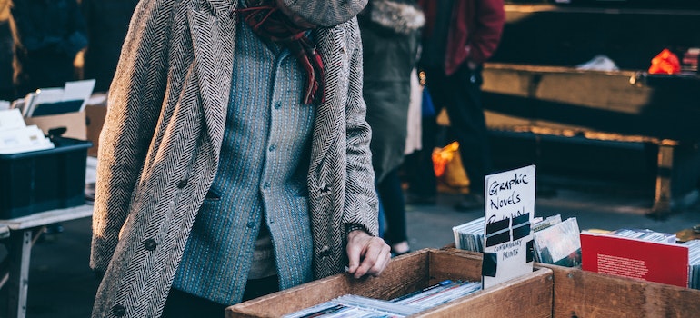 a man at a garage sale, looking to get rid of unwanted items after moving