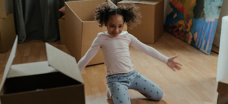 A little girl performing in her house during packing