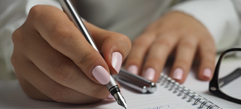 A woman writing something down