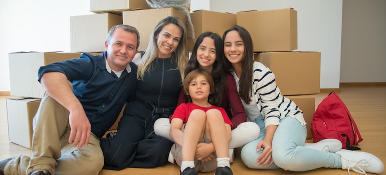 Family posing in front of cardboard boxes