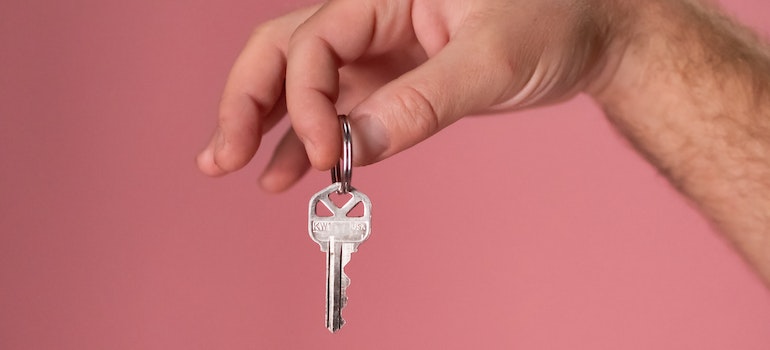 A person holding a key to a home they just bought after moving from New York to Pennsylvania 