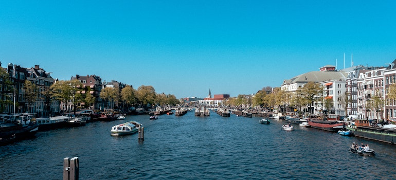 Amsterdam canals on a sunny day to visit after moving to Amsterdam from US