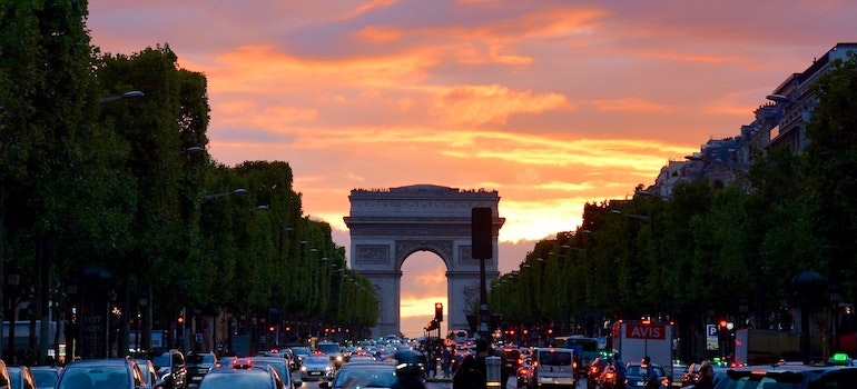 Arc De Triomphe at sundown with traffic in front