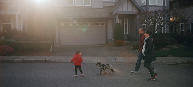 A family walking down the road in one of the best neighborhoods for families in Portland