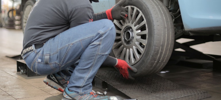 A man checking tire pressure