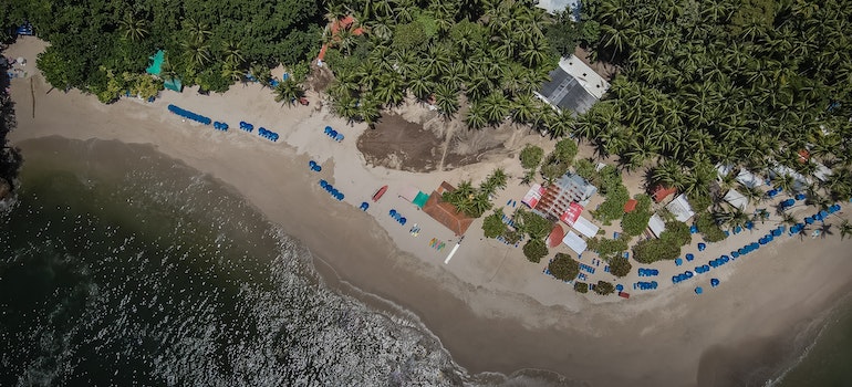 Areal view of a beach with house people are living in after moving to Costa Rica from US