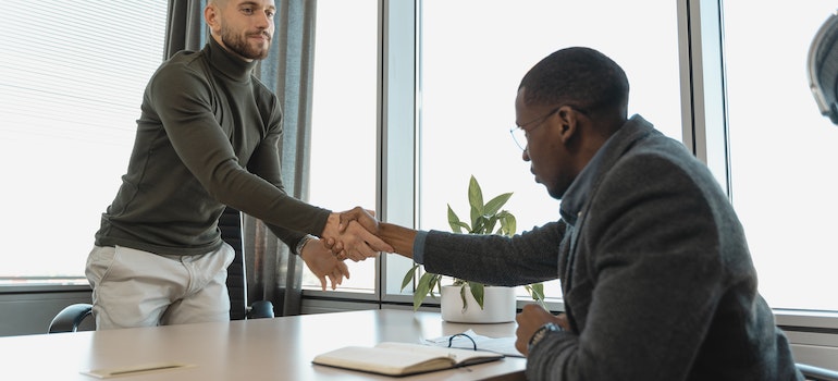 Man giving another man a handshake after a job interview