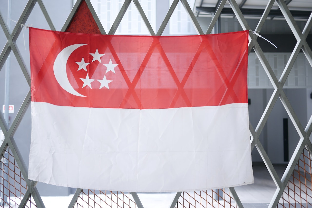 Singapore flag hanging on a gate