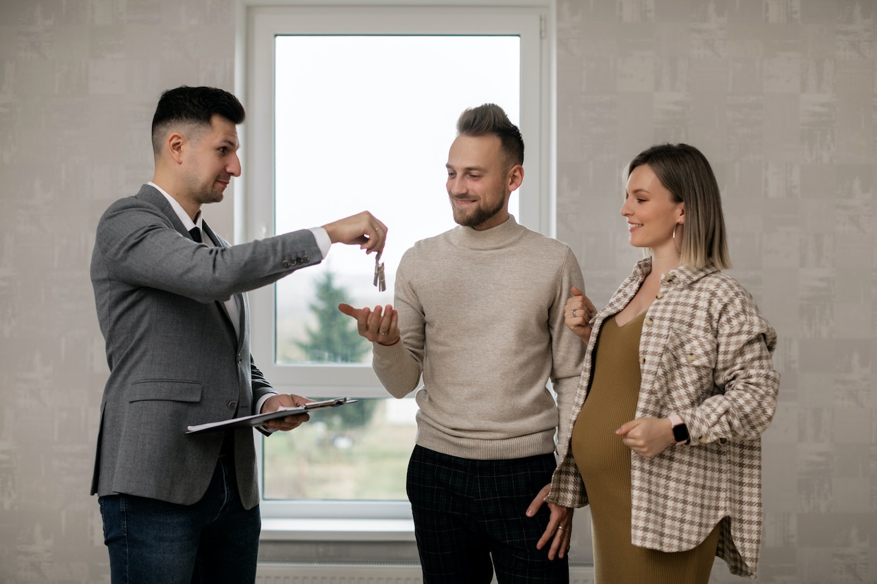 A couple taking keys of a home and building strong relationships with real estate agents