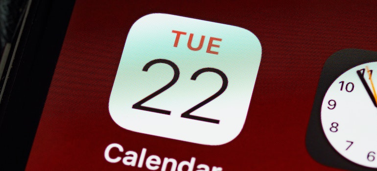 A close up photo of a calendar app on the phone used to create a home maintenance schedule after a move