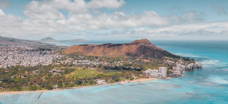 A photo from a drone looking at Honolulu beach and buidling on the waterfront