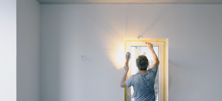 Man using a flashlight to check his doorway