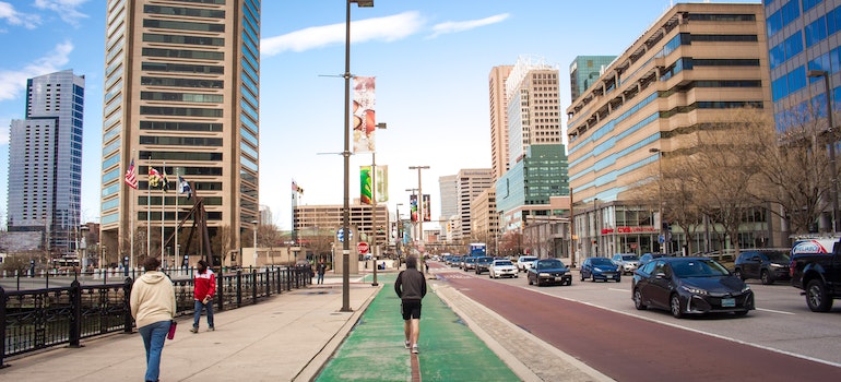Baltimore streets and a pedestrian walking on the biking lane
