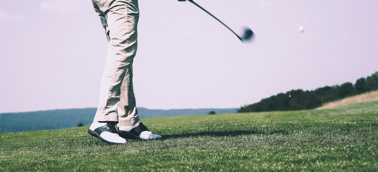 A man playing golf on a golf course in New Hampshire