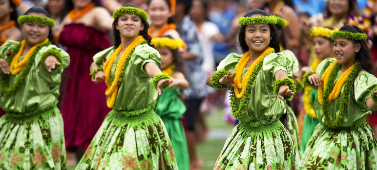 girls in green Hawaiian dresses dancing during a festival