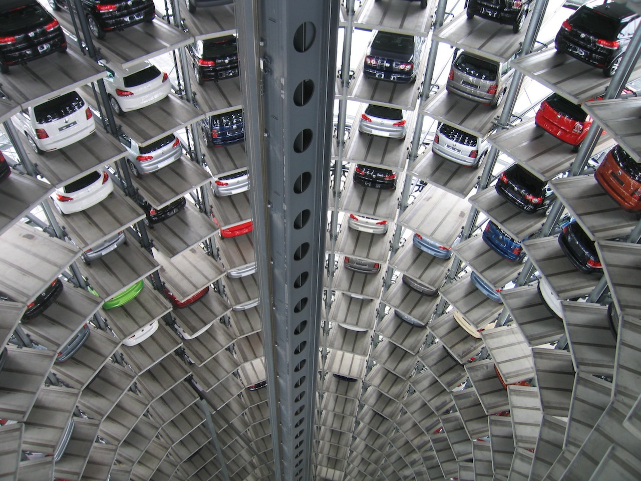 Vehicles parked in a white circular parking with a lot of floors