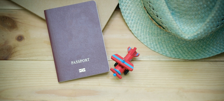 A toy plane, a hat, and a blank passport