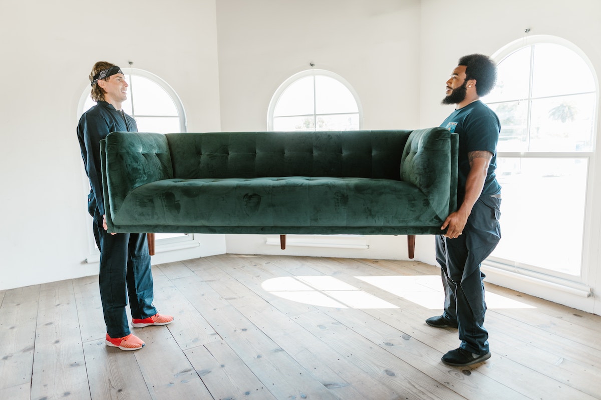 Two men carrying the furniture