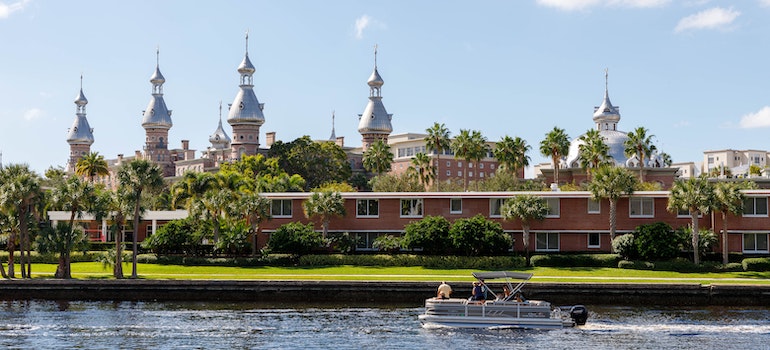 University of Tampa Florida view from across the water, with a boat driving by with people looking for best cities in Florida for job seekers