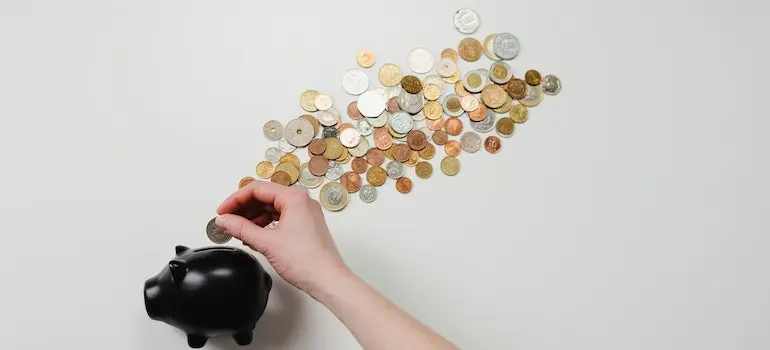 Piggy bank with scattered coins